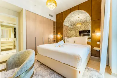 a bedroom with a large bed and a mirror at Elegant 1BR, Easy Access to Creek Harbour Night Vision - Summer at Creek Beach Building 3 by Deluxe Holiday Homes in Dubai