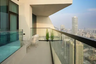a balcony with a view of a city at Luxury Apartment with Private Pool & Gym in Dubai