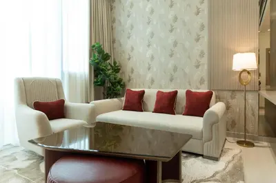 a living room with a couch and a table at Luxury Apartment with Private Pool & Gym in Dubai