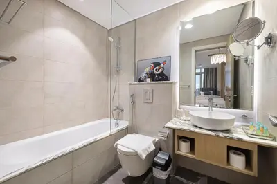 a bathroom with a dog sitting on top of a sink at Famous Sky Pool at Paramount's King's 2BR in Dubai