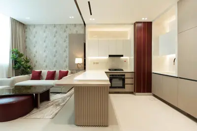 a kitchen and living room with a couch and a table at Designer Apartment with Private Pool in Dubai