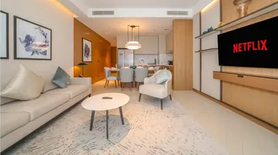 a living room with a couch and a tv at Prestige 3Bed with Full Iconic Burj Khalifa Views in Dubai