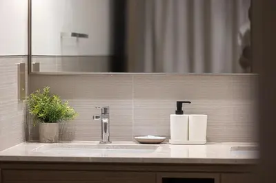a bathroom sink with a faucet and a mirror at Burj Khalifa Front Ultra Luxe Designer Residence in Dubai