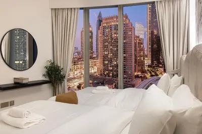 two beds in a hotel room with a view of a city at Burj Khalifa Front Ultra Luxe Designer Residence in Dubai