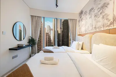 a hotel room with two beds and a large window at Burj Khalifa Front Ultra Luxe Designer Residence in Dubai
