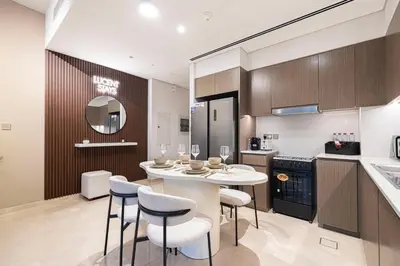 a kitchen with a table and chairs in a kitchen at Burj Khalifa Front Ultra Luxe Designer Residence in Dubai