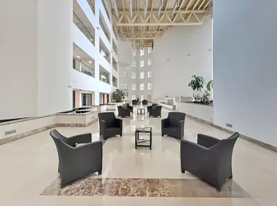 a lobby with chairs and tables in a building at Luxury High-Floor Suite Museum of the Future View in Dubai
