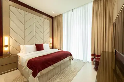 a hotel room with a bed and a large window at Elegant High-Floor Apartment with Pool in Dubai