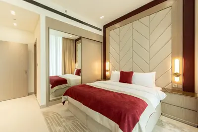 a bedroom with a large bed and a mirror at Elegant High-Floor Apartment with Pool in Dubai