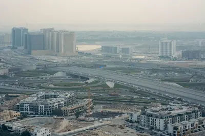 an aerial view of a city with a highway at Elegant High-Floor Apartment with Pool in Dubai