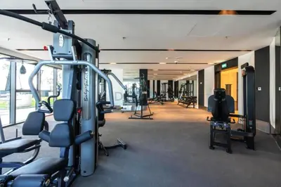 a gym with cardio equipment in a building at High-Floor 2BR with Vibrant Street Views and Effortless Drive Access to Downtown Hotspots, Nobles Tower, Business Bay by Deluxe Holiday Homes in Dubai
