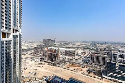an aerial view of a city with tall buildings at Stylish 1BR Sobha The Crest Pool & City View in Dubai