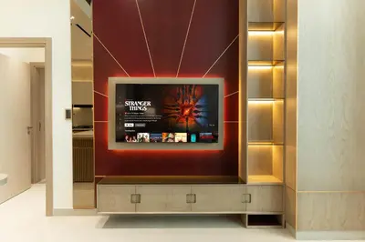 a television in a room with a wall at Modern Apartment with Private Balcony Pool in Dubai