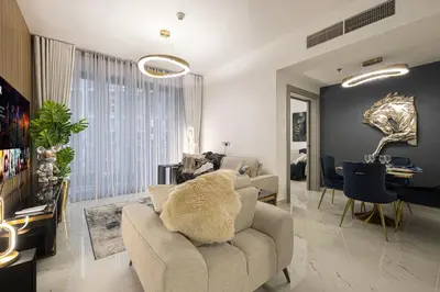 a living room with a couch and a chair at Spacious 1BR & Study Burj Khalifa View, Downtown in Dubai