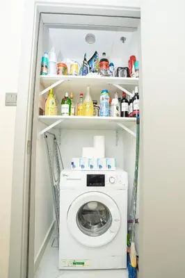 a washer and dryer in a small room at Spacious 1BR & Study Burj Khalifa View, Downtown in Dubai