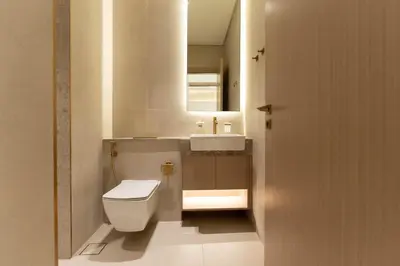 a bathroom with a white toilet and a sink at Luxury Apartment with Private Pool in JVC in Dubai