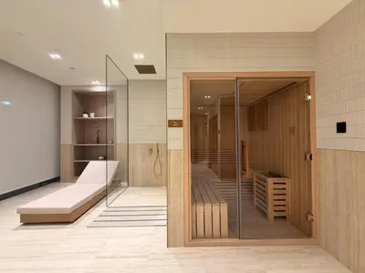 a room with a glass door in a room with a bed at Luxury Apartment with Private Pool in JVC in Dubai