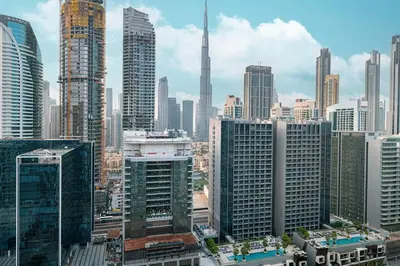 a view of a large city with tall buildings at Designer 2BR with Burj View 5 Min to Dubai Mall in Dubai
