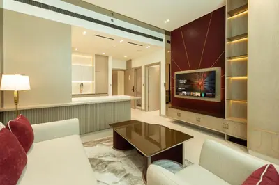 a living room with a couch and a tv at Luxury City Apartment with Private Pool in Dubai