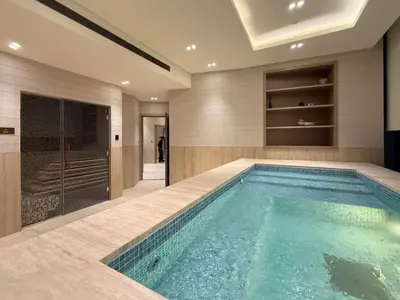 a swimming pool in a bathroom with a walk in shower at High-End Apartment with Balcony Pool in Dubai
