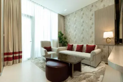 a living room with a couch and a table at Sophisticated Apartment with Private Pool in Dubai