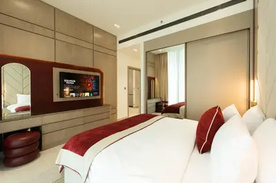 a bedroom with a large bed and a flat screen tv at Sophisticated Apartment with Private Pool in Dubai