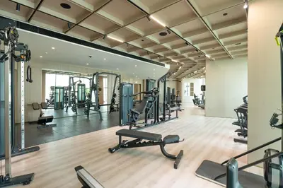 a gym with tread machines and a mirror at Sophisticated Apartment with Private Pool in Dubai