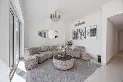 a living room with a couch and a coffee table at Elite Escapes - Glamorous Damac Heights - 2 BR in Dubai