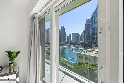 a room with a window with a view of a city at Elite Escapes - Glamorous Damac Heights - 2 BR in Dubai