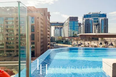a swimming pool on top of a building with buildings at LUX Iconic Views at The Palm Tower Suite 7 in Dubai