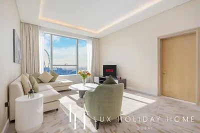 a living room with a couch and a table at LUX Iconic Views at The Palm Tower Suite 7 in Dubai