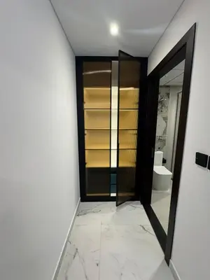 a bathroom with a glass door and a toilet at Opalz 1 bhk luxury apt for family and couple with swimming pool in Dubai