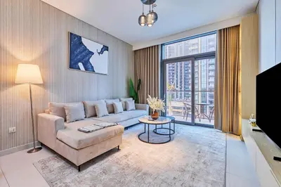 a living room with a couch and a large window at Premium 2BR Residence in Downtown Dubai in Dubai