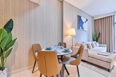 a living room with a table and a couch at Premium 2BR Residence in Downtown Dubai in Dubai