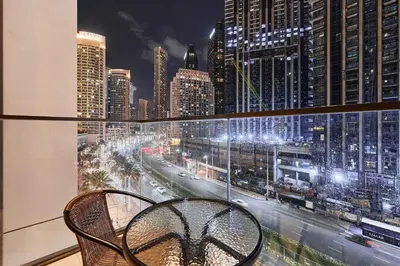 a balcony with a view of a city at night at Premium 2BR Residence in Downtown Dubai in Dubai