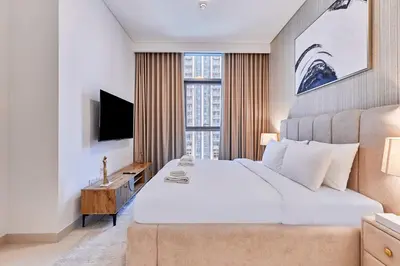 a bedroom with a large bed and a large window at Premium 2BR Residence in Downtown Dubai in Dubai