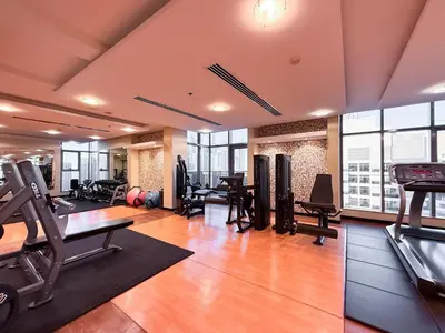 a gym with treadmills and exercise equipment in a building at GuestReady - 1BR | JLT Apt near Metro Station in Dubai