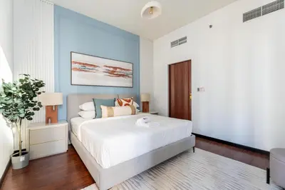 a bedroom with a large white bed and blue walls at GuestReady - 1BR | JLT Apt near Metro Station in Dubai