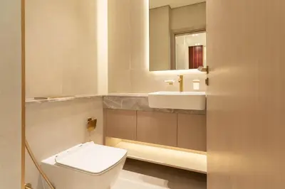 a bathroom with a toilet and a sink and a mirror at Refined High-Floor Apartment with Pool in Dubai