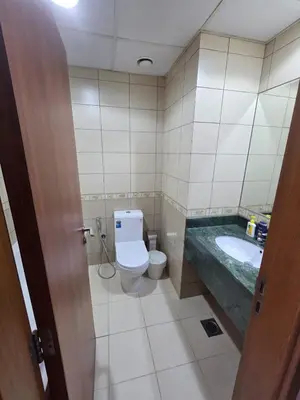 a bathroom with a toilet and a sink at Skycourts - Well furnished Studio apartment in Dubai