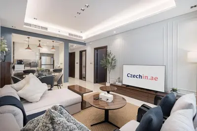 a living room with a couch and a tv at Modern Chic 1BHK Nobles Tower by Czechin in Dubai
