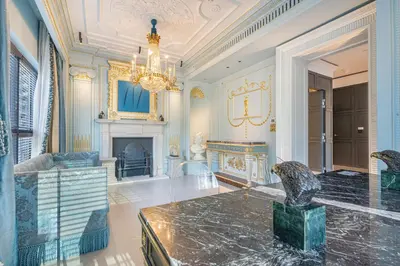 a large living room with a chandelier and a fireplace at Chic Central Downtown Home with Burj View in Dubai