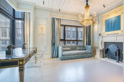 a living room with a couch and a chandelier at Chic Central Downtown Home with Burj View in Dubai
