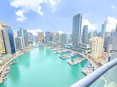 a view of a river with boats in a city at Marina Breeze - Serene Yacht Views near Ain Dubai 3 BR Apartment in Dubai