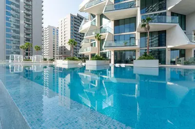 a swimming pool in front of a building at Premium Apartment with Private Balcony Pool in Dubai
