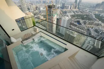 a balcony with a swimming pool on top of a building at Exclusive Luxury Apartment with Private Pool in Dubai