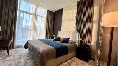 a bedroom with a bed and a large window at Stunning Canal View Studio Business Bay in Dubai