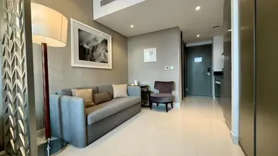 a living room with a couch and a table at Stunning Canal View Studio Business Bay in Dubai