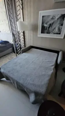 a bed in a room with a picture on the wall at Stunning Canal View Studio Business Bay in Dubai