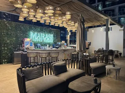 a restaurant with a bar with chairs and a table at Stunning Canal View Studio Business Bay in Dubai